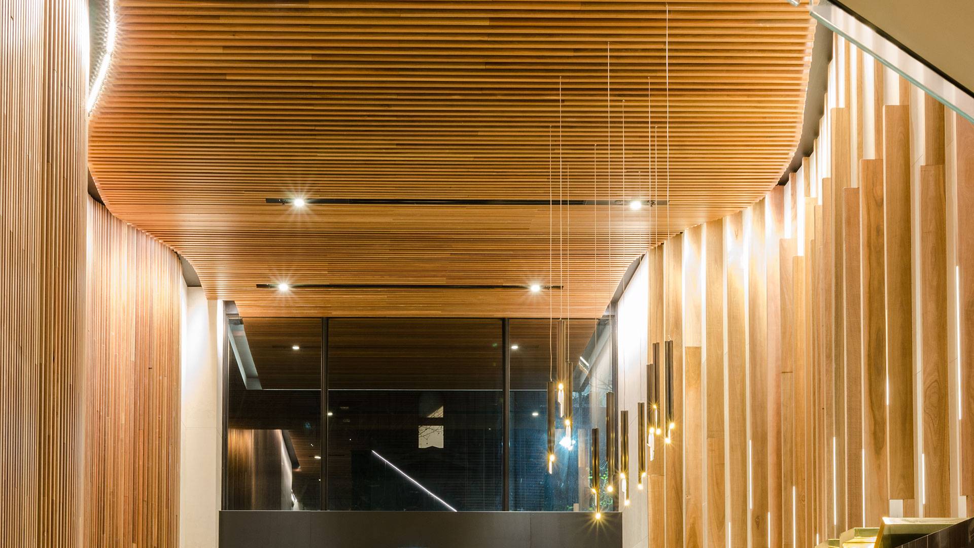 Aris linear grazer illuminates the custom timber battens in the main lobby entrance.