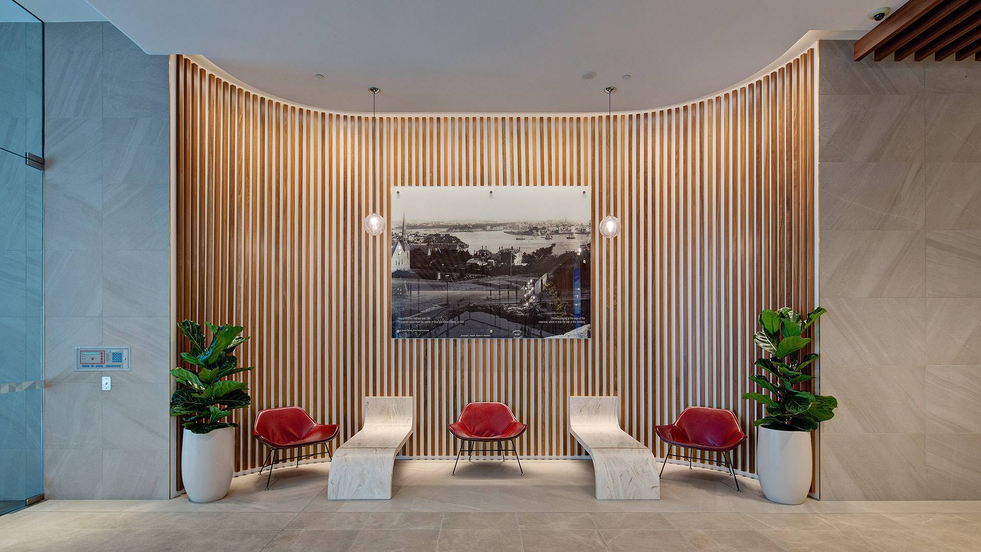 Precise illumination of the lobby features at 40 Miller Street, including grazing timber panelling on curved walls with Aduro CL.
