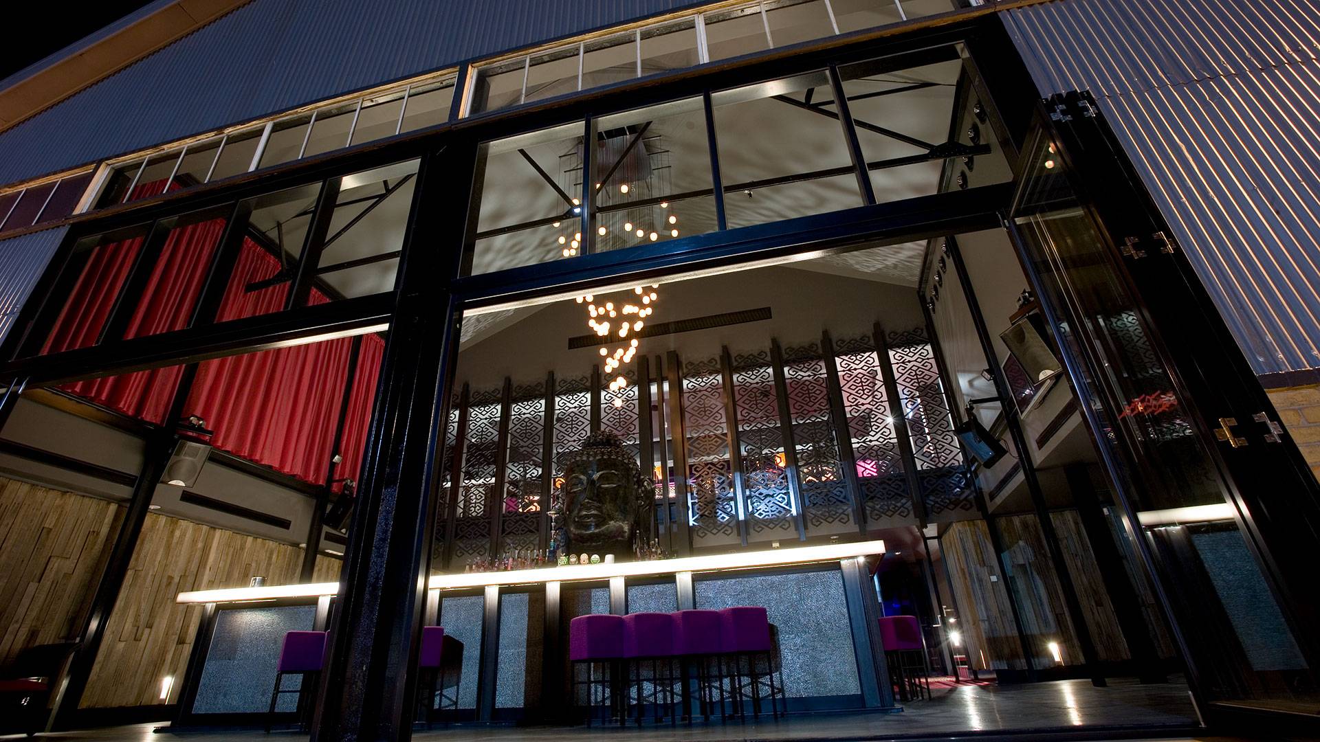 ELS Downlights were used to up-light the Buddha feature wall in the main room, casting coloured shadows over the bronze crevices. Square and round DMX panels were used in the bar tables.
