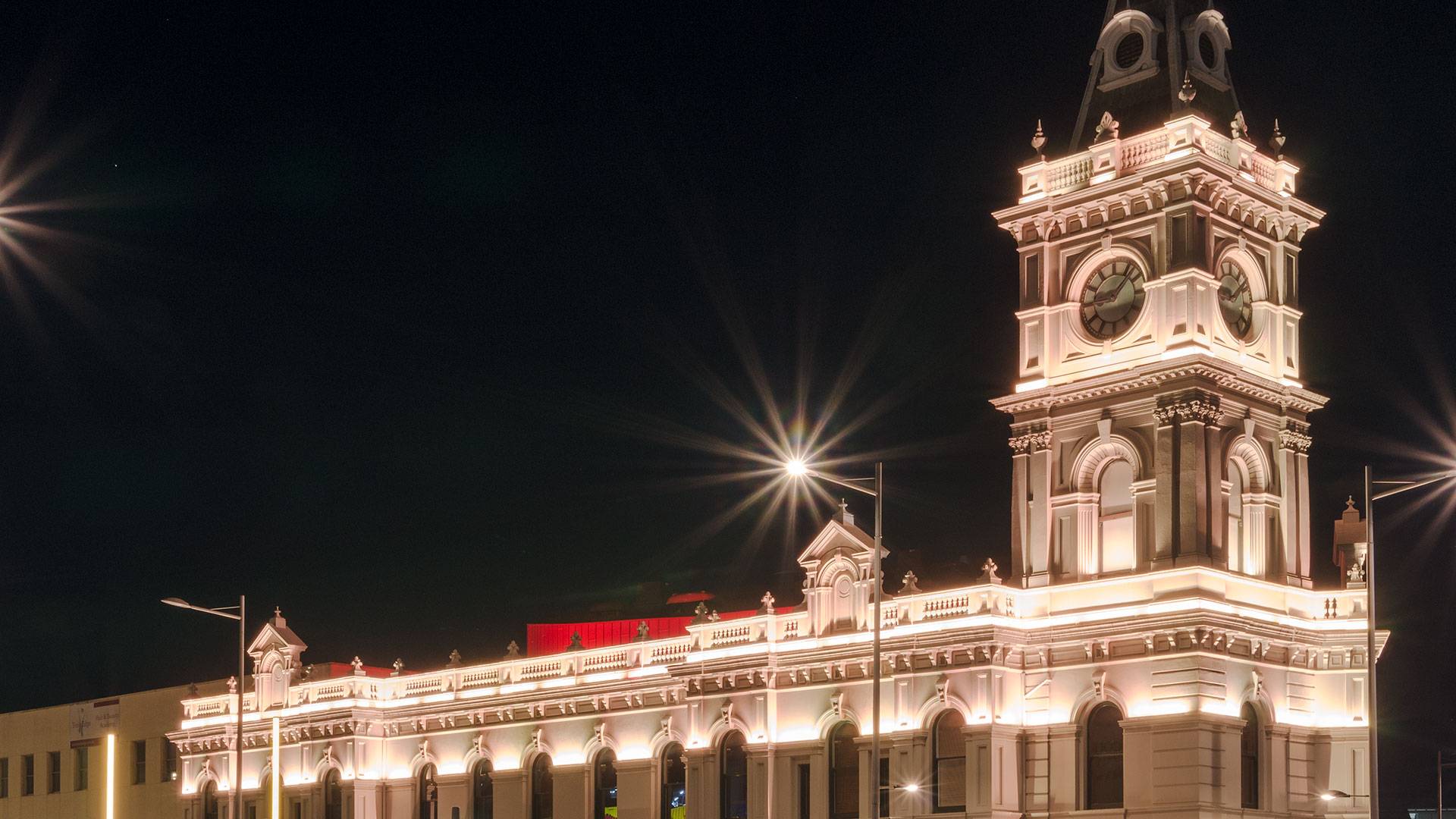 Latitude LED luminaire in application, installed on the façade of the former Dandenong Town Hall, now known as the Drum Theatre in Melbourne. Night view.