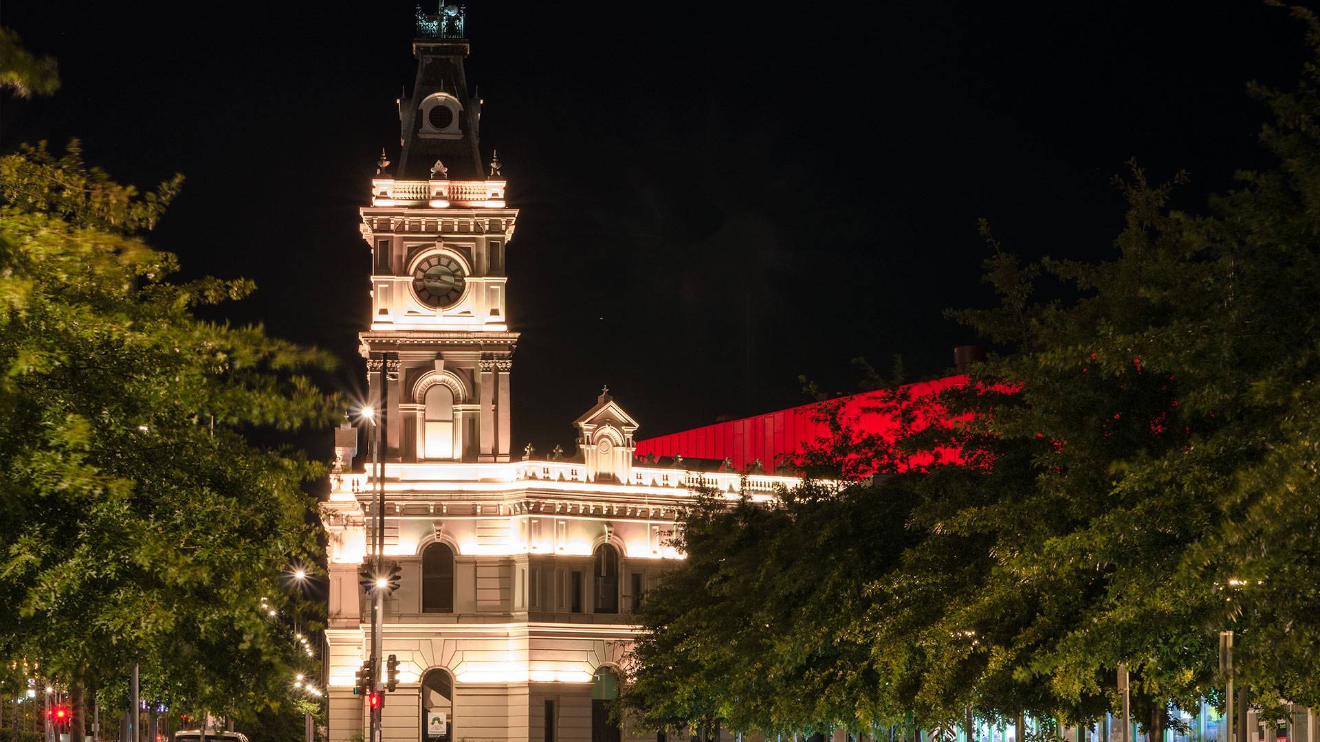 Latitude LED luminaire in application, installed on the façade of the former Dandenong Town Hall, now known as the Drum Theatre in Melbourne. Night view.