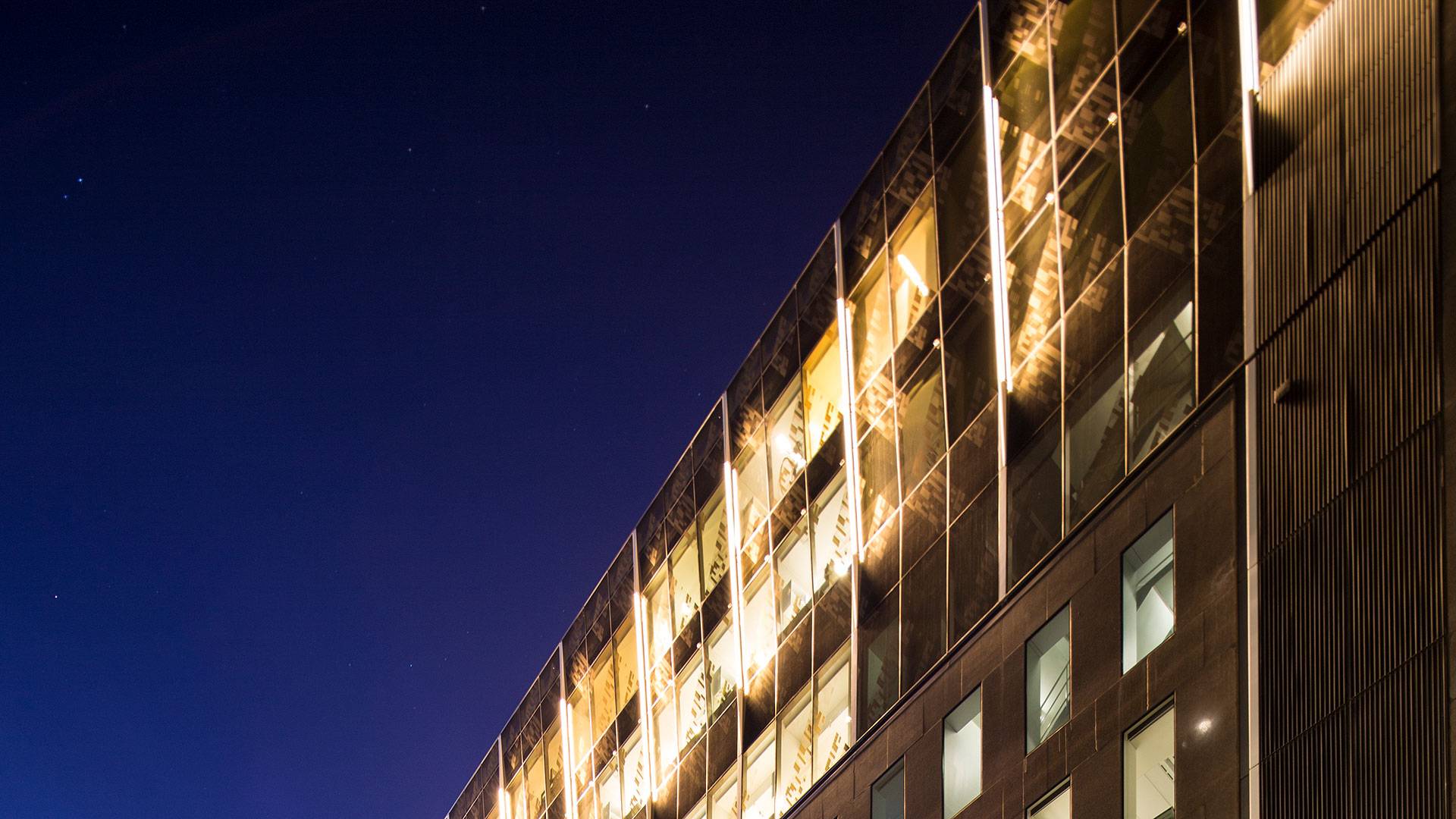 Illumination to the façade of the Holding Redlich Building in Bourke Street, Melbourne. 5-meter-long custom Beam was mounted as fin-like luminaries that point towards the glass, and are positioned all around the crown of the building.