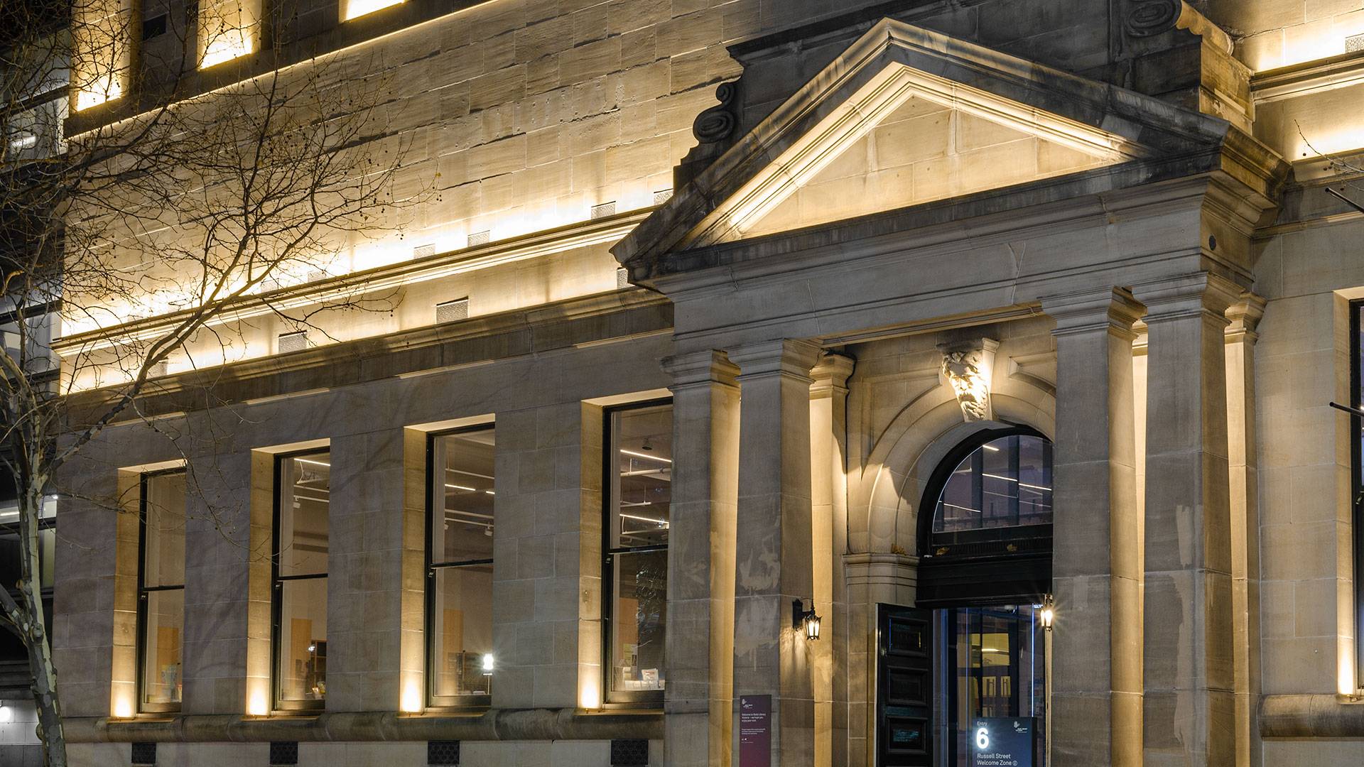 Max Mini IP LED luminaire in application. Discreet Max Mini IP linear floodlights highlight the façade at Melbourne State Library of Victoria.View from the front, the facade is let up.
