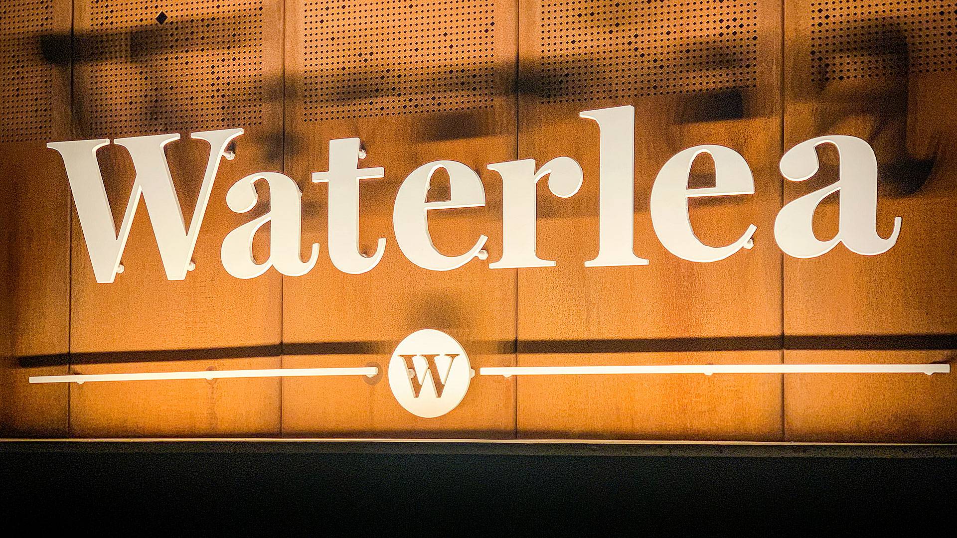 Mounted inside a compact rebate, Max Mini IP gently grazes the Waterlea Village entrace signage.