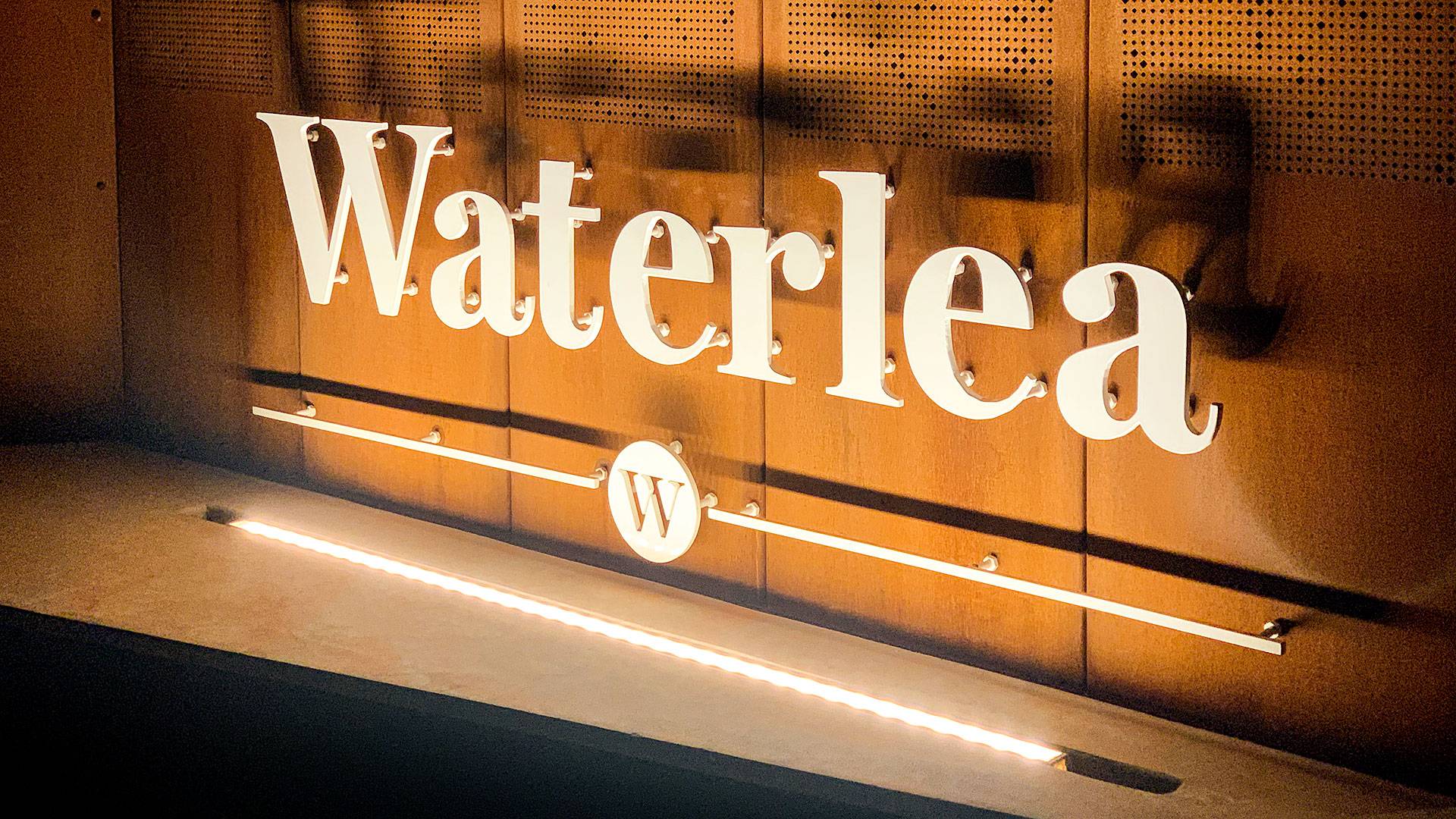 Mounted inside a compact rebate, Max Mini IP gently grazes the Waterlea Village entrace signage.