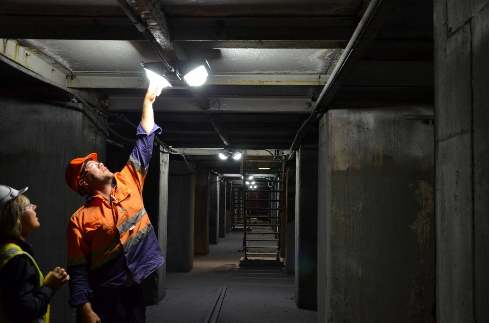 Coolon Tunnel Ray LED industrial lighting installed on a copper mine in northern queensland. View on a mining electrician adjusting the industrial light.