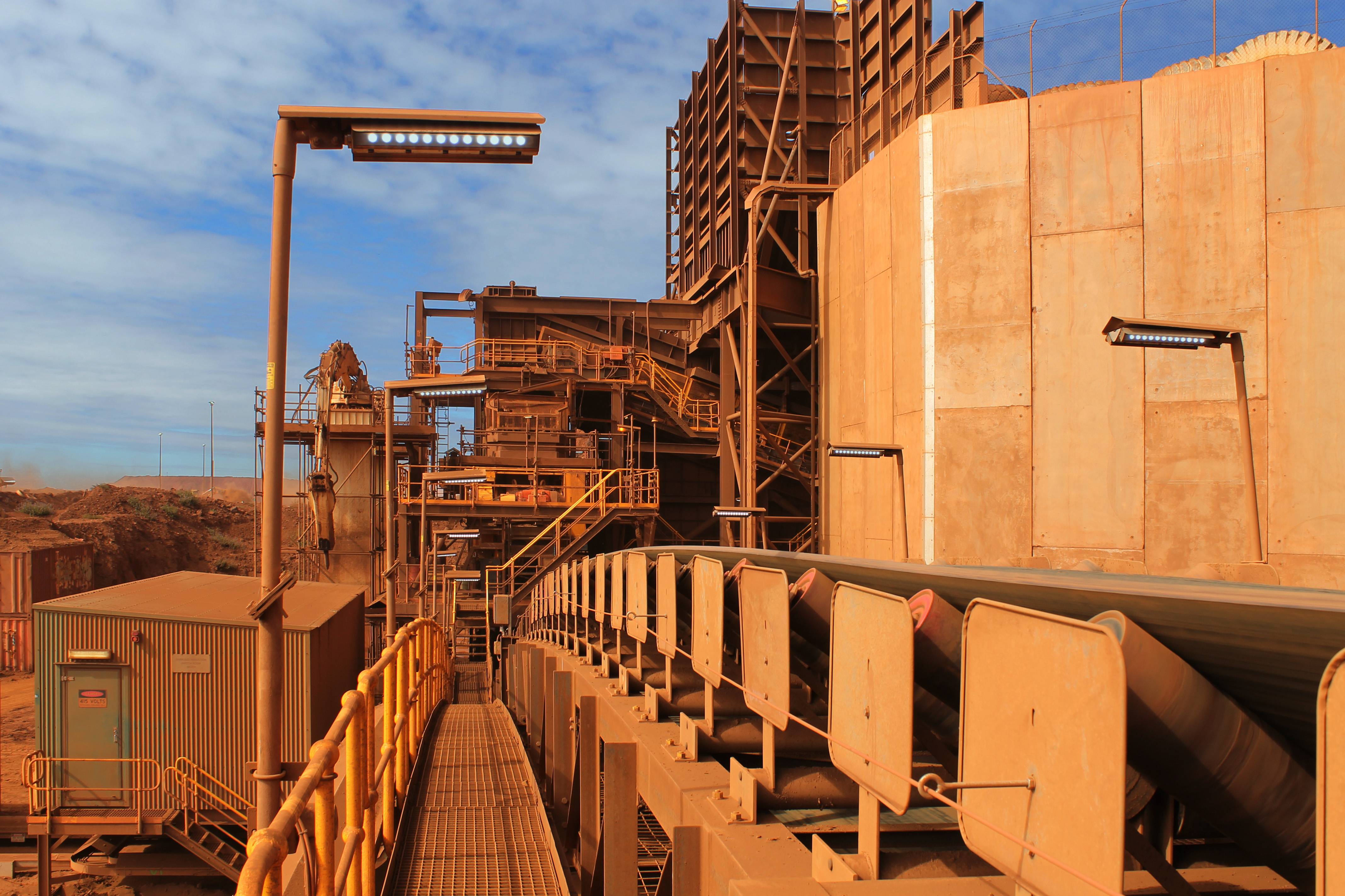 Conveyor belt on an iron ore is illuminated by a range of Coolon fittings.