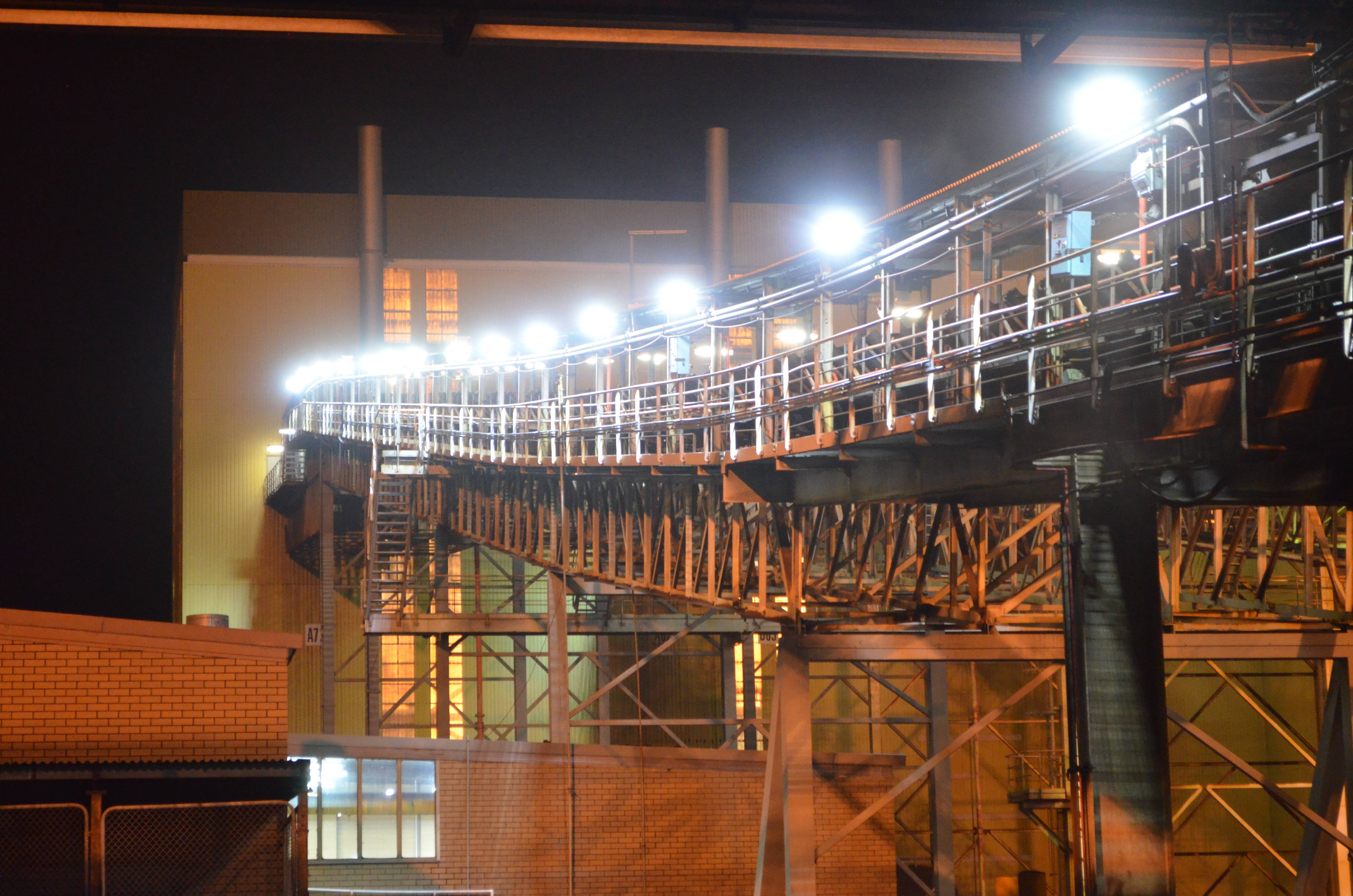 An industrial conveyor on a power plant is lit up with Coolon DLK2s.