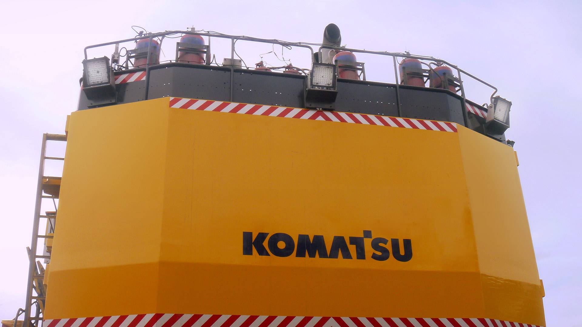 CP56 LED Flood Light in application, installed on a large hydraulic excavator komatsu on an industrial / mine site, view from the back