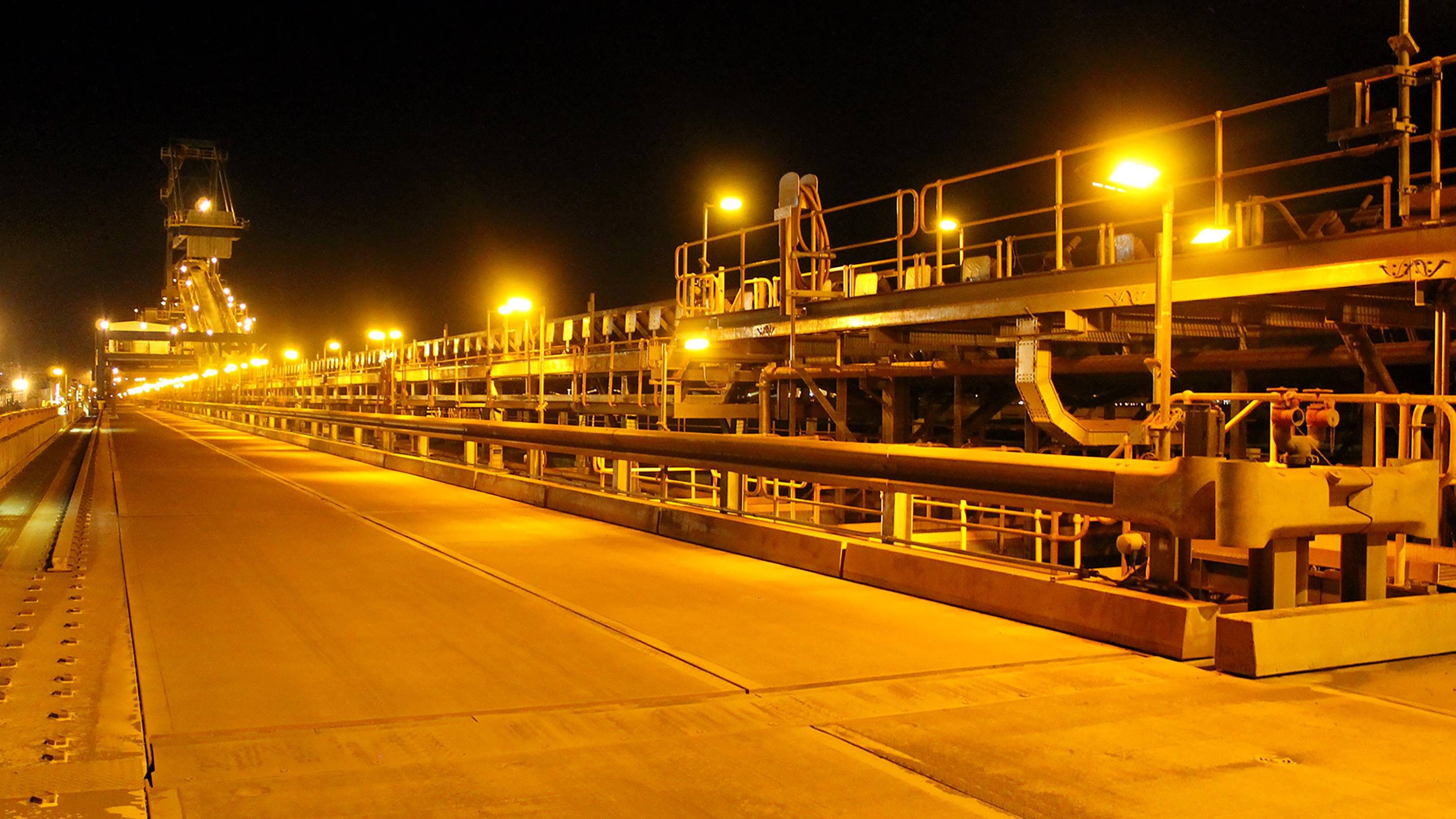 DLK LED Conveyor / Area Light in application, installed on a conveyor on an iron ore mine in bulk port, turtle-friendly amber colour temperature 